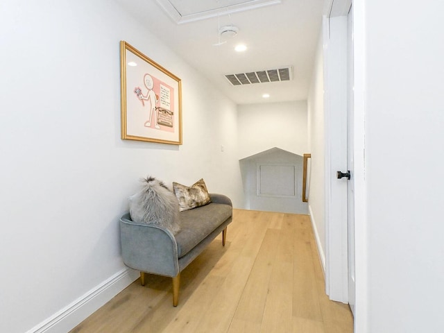 hallway with attic access, visible vents, baseboards, light wood-type flooring, and recessed lighting