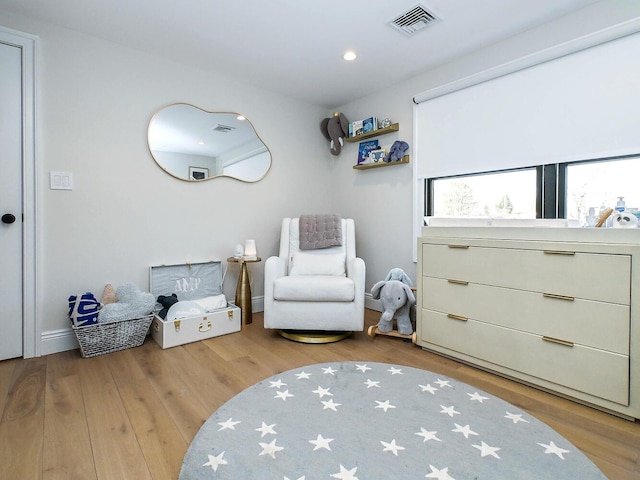 sitting room with visible vents, wood finished floors, and recessed lighting