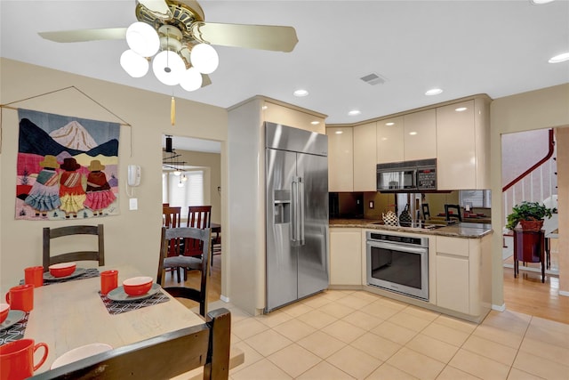 kitchen with black appliances, modern cabinets, light tile patterned floors, and recessed lighting