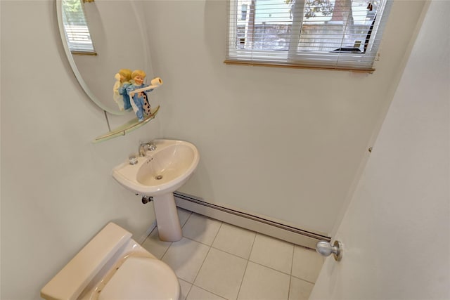 bathroom with toilet, a baseboard radiator, a sink, and tile patterned floors