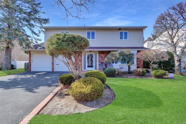 traditional home with aphalt driveway, brick siding, an attached garage, and a front lawn