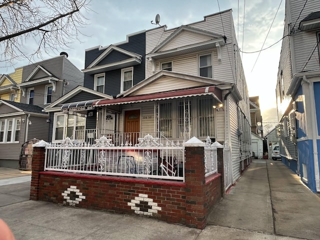 view of front of home with a porch and brick siding