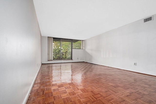 unfurnished room with visible vents and baseboards