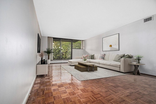 living room featuring baseboards and visible vents