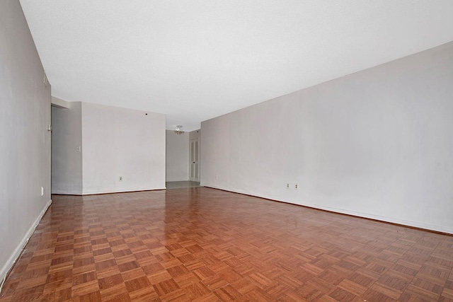 unfurnished room with a textured ceiling