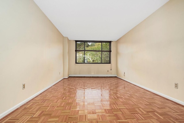 spare room with baseboards