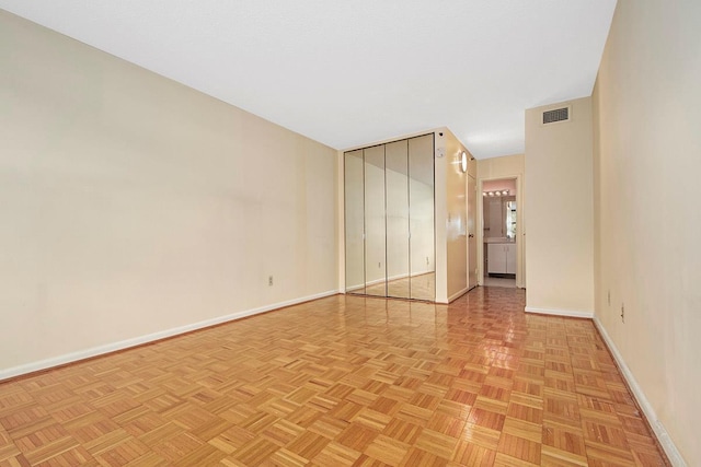 spare room with visible vents and baseboards