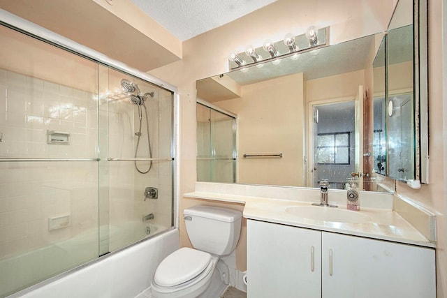 bathroom featuring enclosed tub / shower combo, a textured ceiling, vanity, and toilet