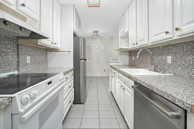 kitchen featuring under cabinet range hood, a sink, white cabinetry, light countertops, and appliances with stainless steel finishes