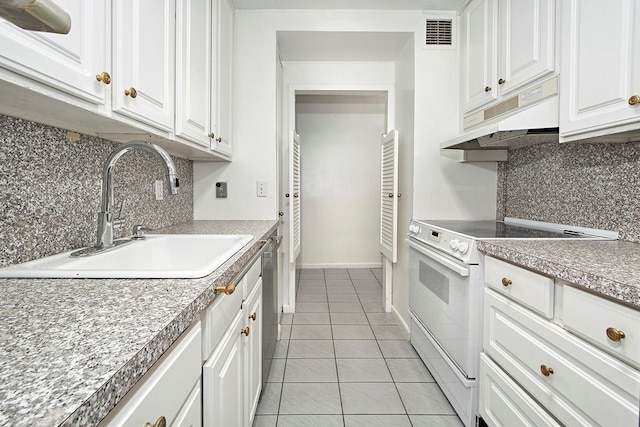 kitchen with light tile patterned floors, white electric range oven, white cabinets, a sink, and under cabinet range hood