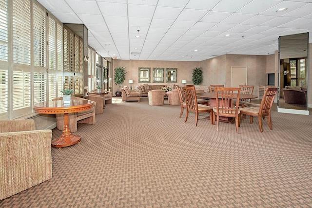 carpeted dining area featuring a paneled ceiling and recessed lighting