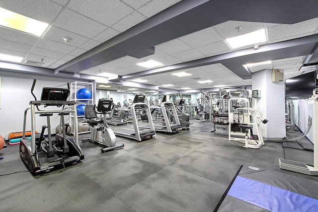 gym with a drop ceiling and visible vents