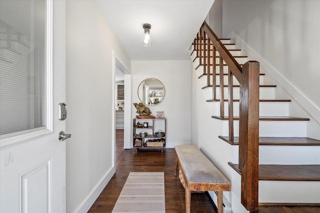 entryway featuring baseboards, stairway, and dark wood finished floors