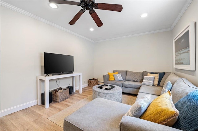 living area with ornamental molding, baseboards, and wood finished floors