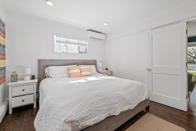 bedroom featuring dark wood-style flooring, a wall unit AC, and recessed lighting