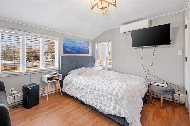 bedroom with vaulted ceiling, a wall mounted AC, baseboard heating, and wood finished floors