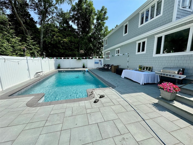 view of pool featuring a patio area, a fenced backyard, and a fenced in pool