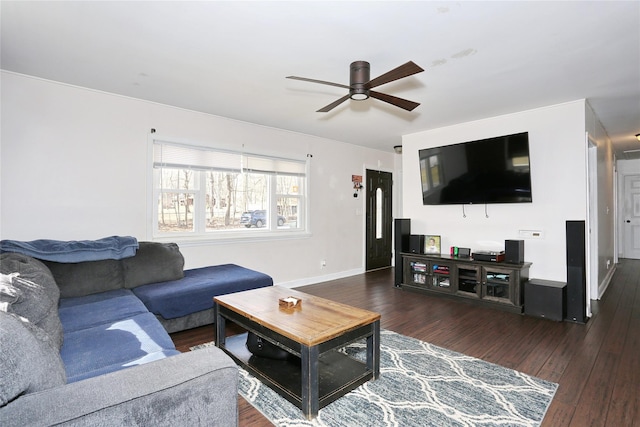 living area with dark wood-style floors, baseboards, and a ceiling fan