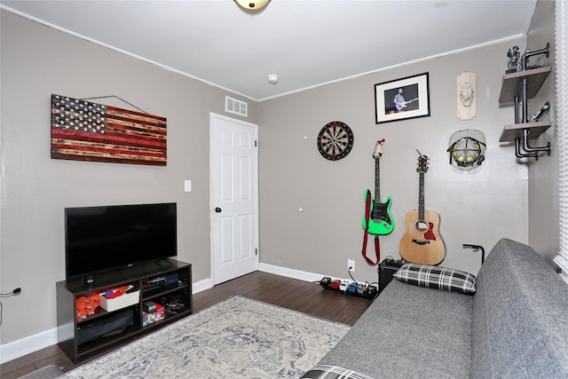 living area featuring visible vents, dark wood finished floors, and baseboards