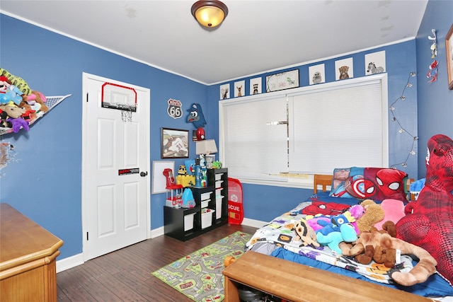 bedroom with dark wood-type flooring and baseboards