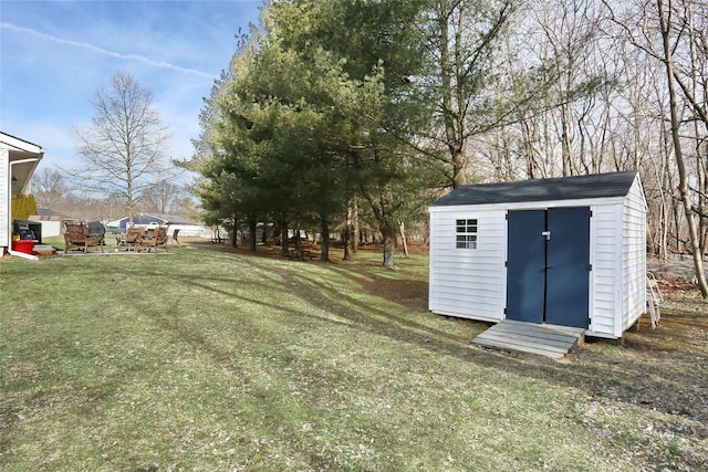 view of yard with an outbuilding and a shed