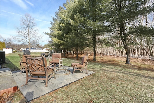 view of yard featuring central AC and a patio area