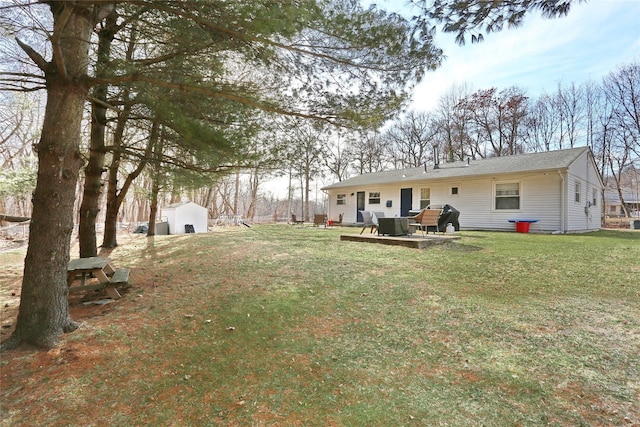 view of yard featuring an outdoor structure, a patio, and a shed