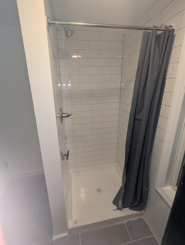 bathroom featuring a stall shower and tile patterned flooring