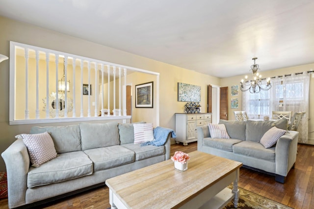 living area featuring dark wood-style flooring and a notable chandelier