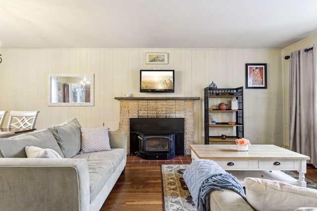 living area with dark wood-type flooring and a wood stove