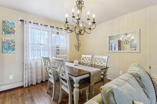 dining room with dark wood finished floors and an inviting chandelier