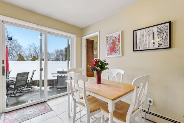 dining area featuring light tile patterned floors and baseboard heating