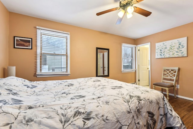 bedroom featuring a ceiling fan, dark wood finished floors, and baseboards