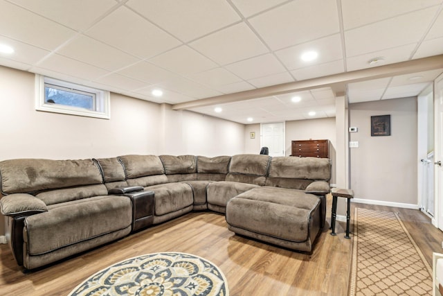 living room with recessed lighting, a drop ceiling, baseboards, and wood finished floors