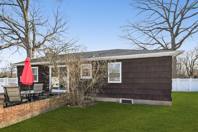 back of house with a patio area, fence, a lawn, and roof with shingles