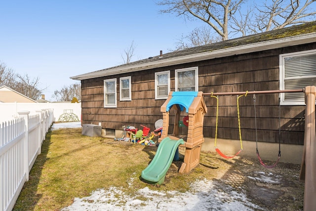 view of play area with a fenced backyard and a yard