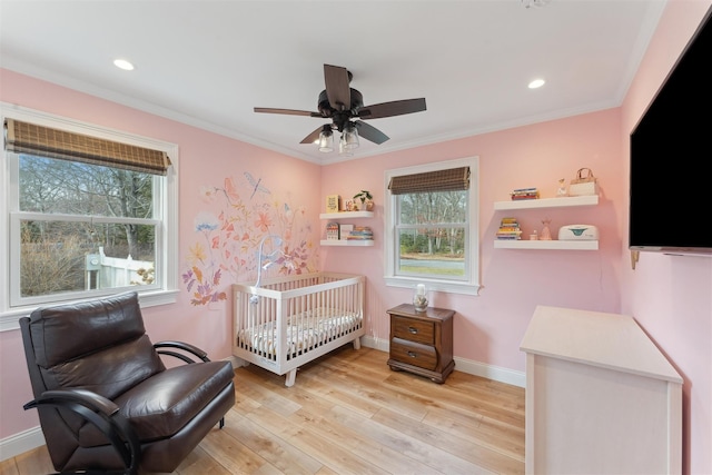 bedroom featuring light wood-type flooring, baseboards, crown molding, and recessed lighting