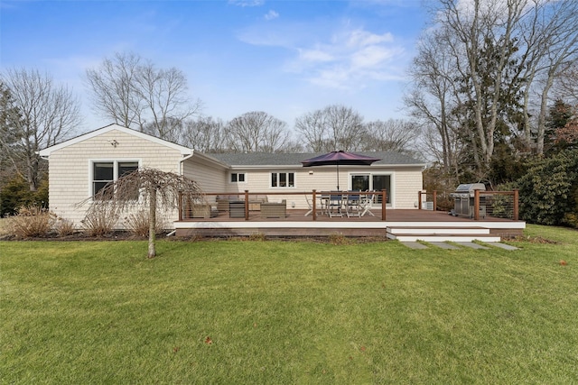 back of property featuring outdoor dining space, a yard, and a deck