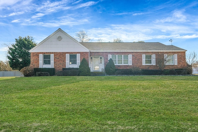 ranch-style house featuring a front yard and brick siding