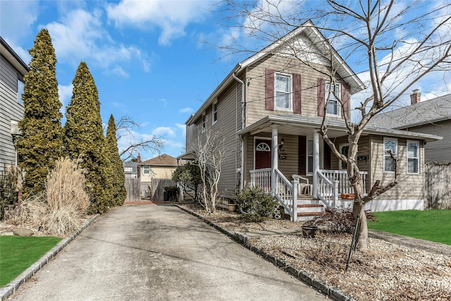 view of front of house featuring a porch and fence