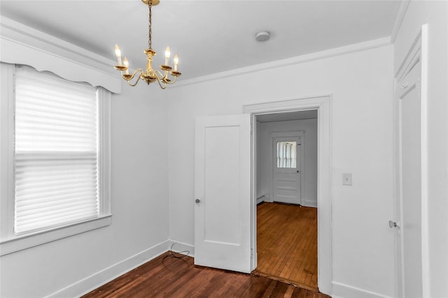 empty room featuring a baseboard heating unit, ornamental molding, dark wood-style flooring, and baseboards