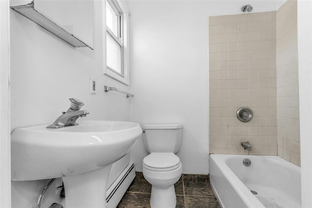 bathroom with toilet, a baseboard radiator, washtub / shower combination, and a sink