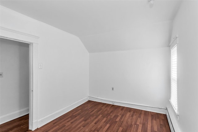 bonus room featuring a wealth of natural light, lofted ceiling, dark wood finished floors, and a baseboard radiator