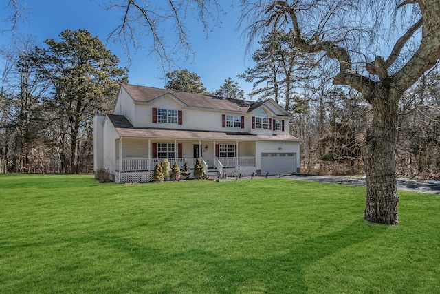 view of front of property with covered porch, driveway, a front lawn, and an attached garage