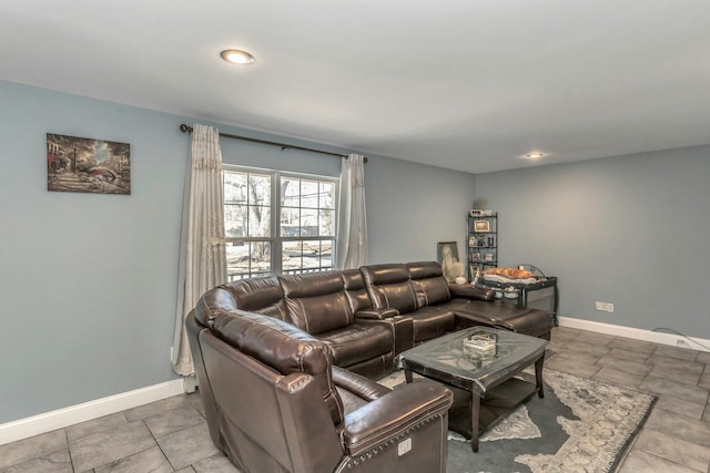 living room featuring baseboards and recessed lighting