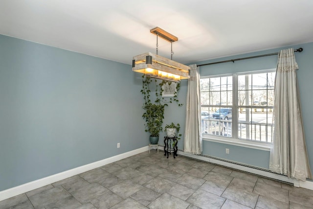 unfurnished dining area with a baseboard radiator and baseboards