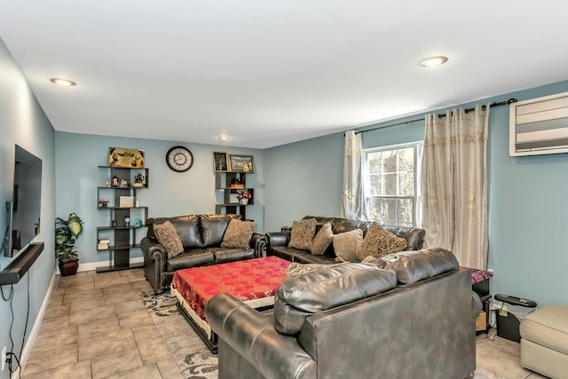 living area with recessed lighting, an AC wall unit, stone finish flooring, and baseboards