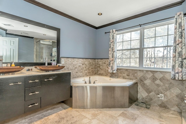 bathroom featuring ornamental molding, vanity, visible vents, and tile walls