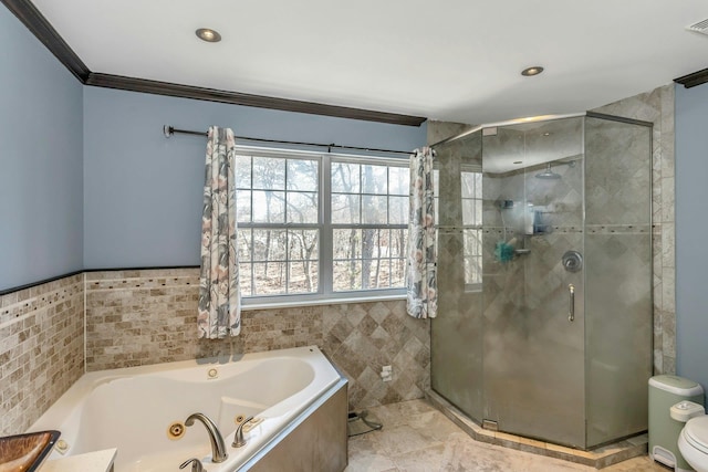 full bathroom with crown molding, tile walls, toilet, a stall shower, and a whirlpool tub