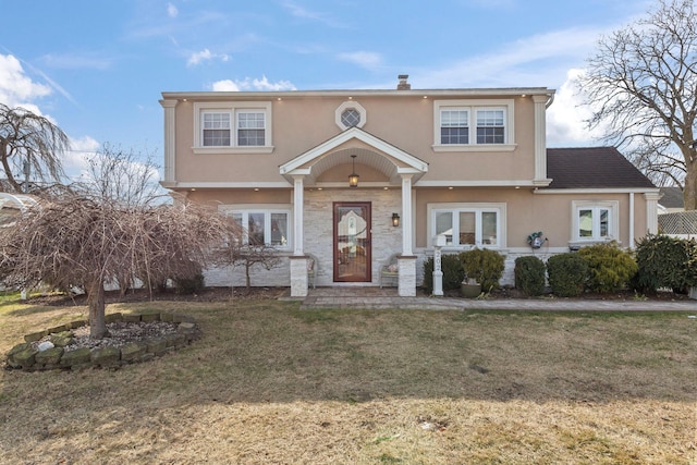 view of front of property with a front lawn and stucco siding